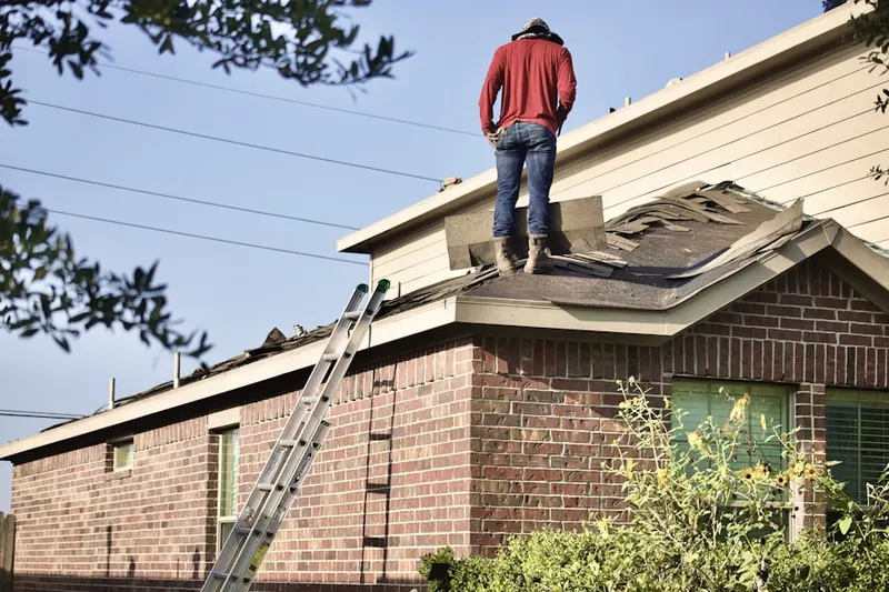 Professional roofer working on a residential roof in Heaton